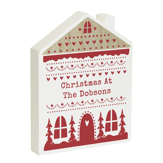 Personalised wooden house decoration with festive red Christmas design and the wording “Christmas At The Dobsons.” Featuring heart, snowflake, and tree motifs, this charming piece adds a cosy, custom touch to seasonal home décor.