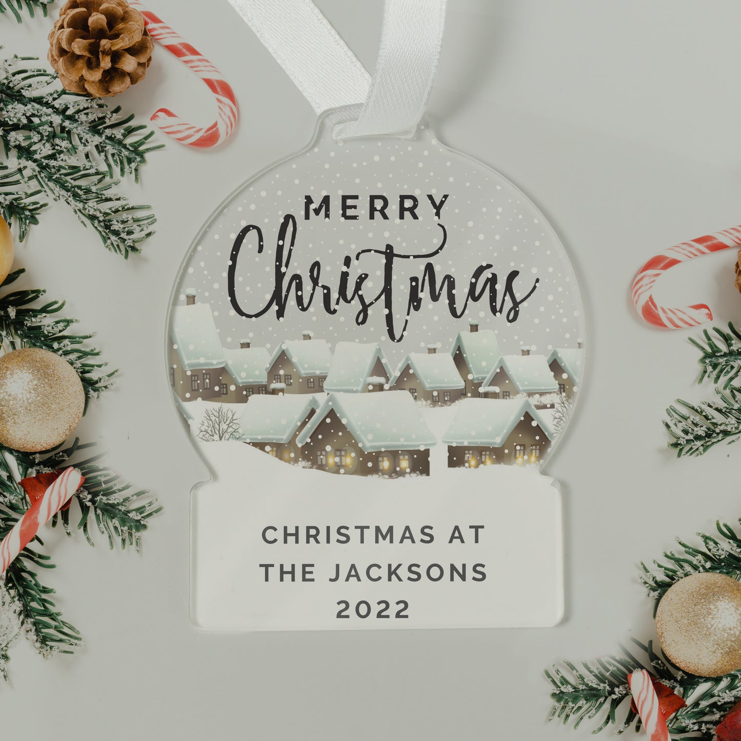 Personalized Christmas ornament with 'Merry Christmas' and 'Christmas at The Jacksons 2022' text, surrounded by festive decorations.