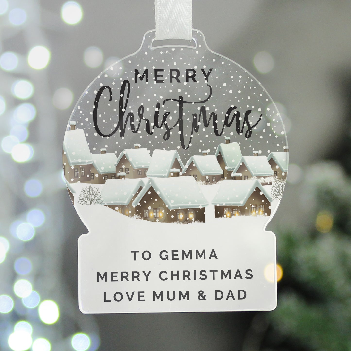 Personalised Christmas ornament with a snowy village scene and personalised text.