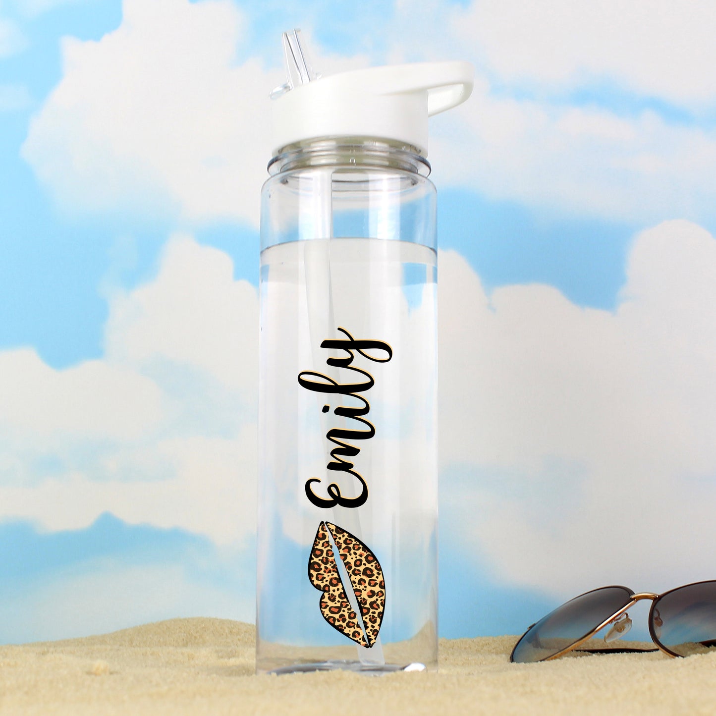 Clear water bottle with 'Emily' and a leopard print design on a beach background