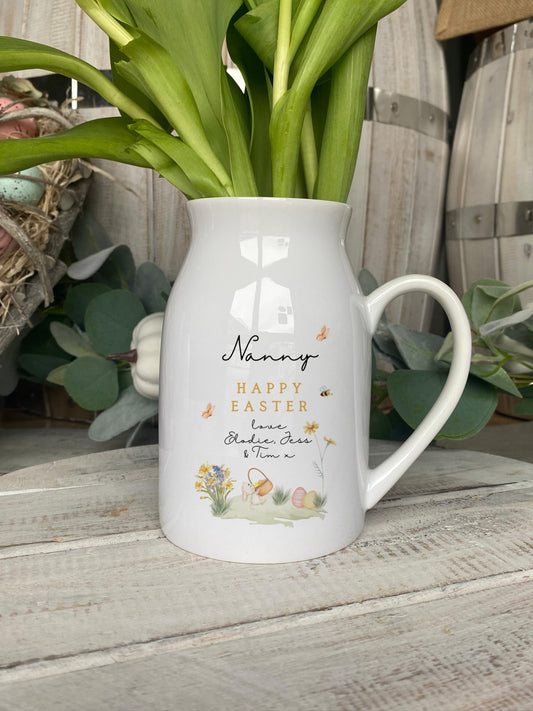 White ceramic jug with 'Happy Easter Nanny' message, featuring illustrated flowers, Easter eggs, butterflies, and personalised text
