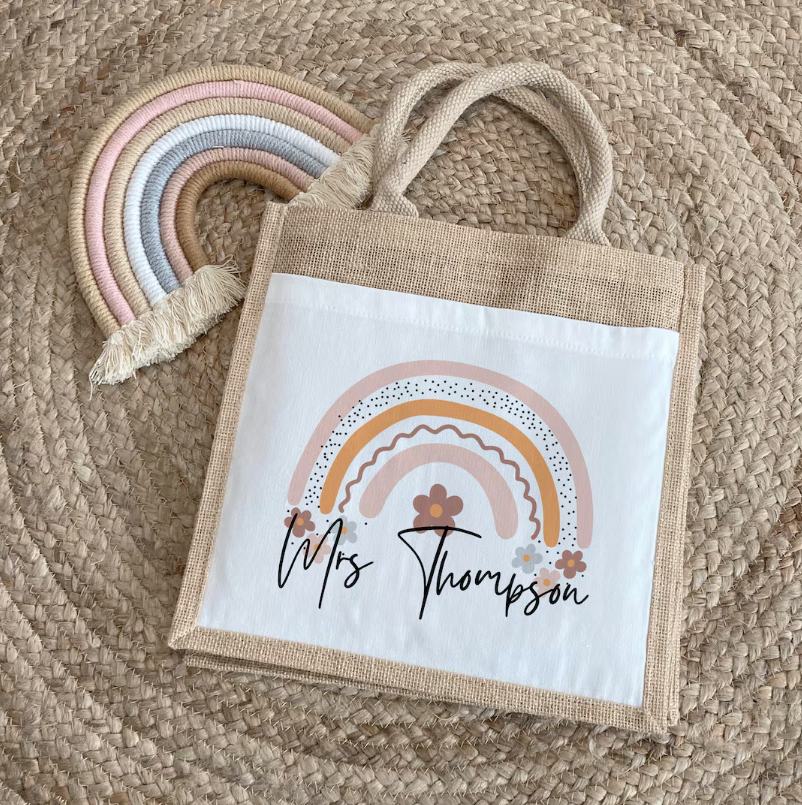 Unique personalised jute tote bag with pastel rainbow and floral design, featuring the name Mrs Thompson – ideal teacher gift or thank you present from students.