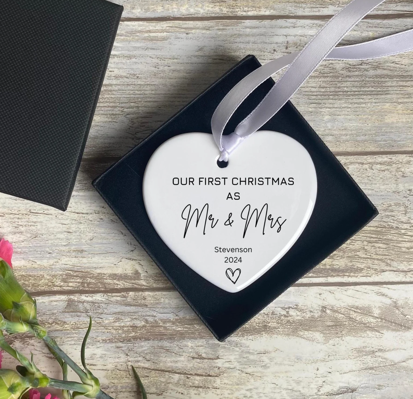 First Christmas as Mr & Mrs 2024 ornament, personalised with the surname “Stevenson.” Heart-shaped ceramic decoration ideal for wedding or engagement gifts, presented in a luxury gift box. A romantic Christmas keepsake for married couples to treasure.