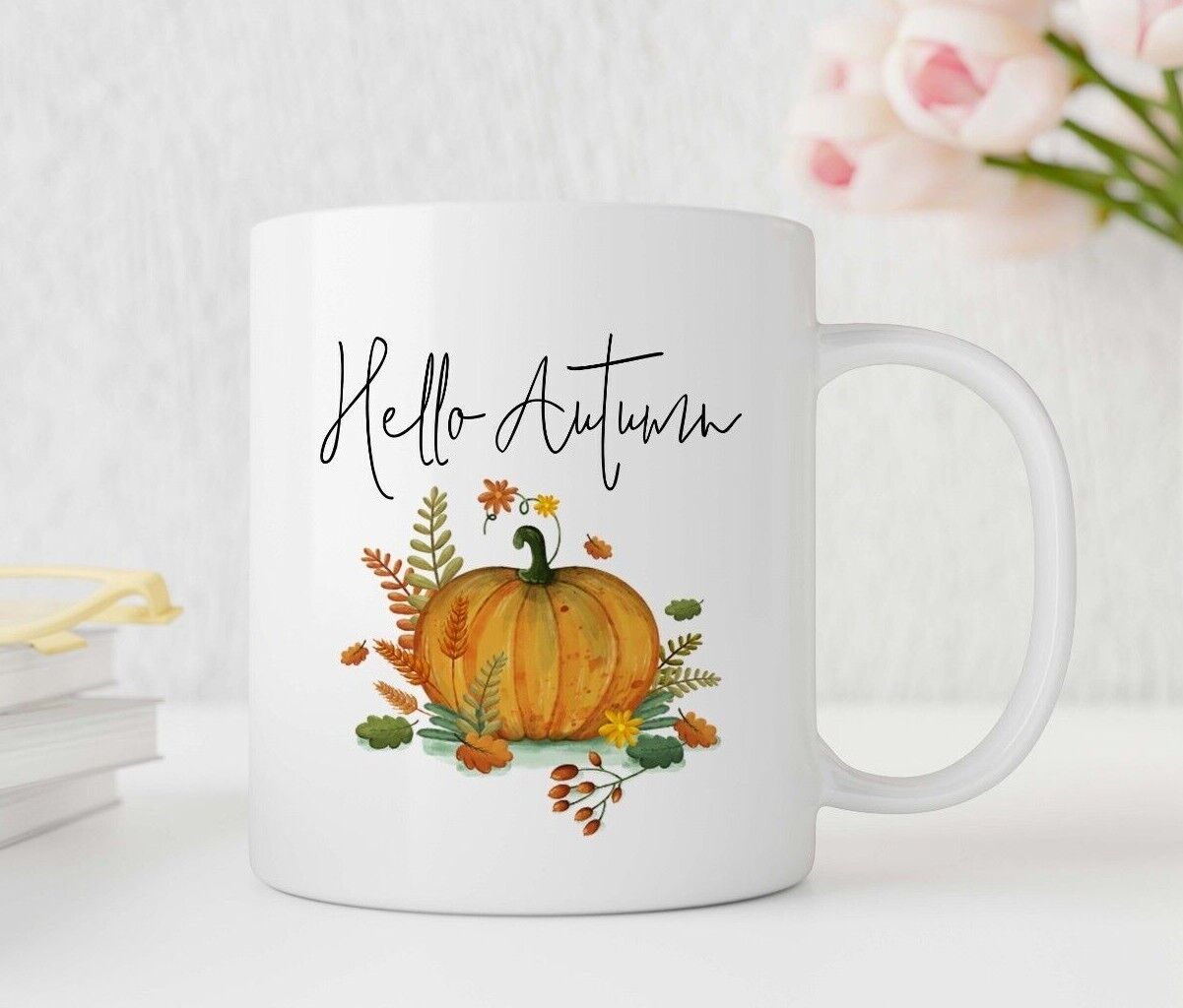 White mug with 'Hello Autumn' text and pumpkin design on a white background