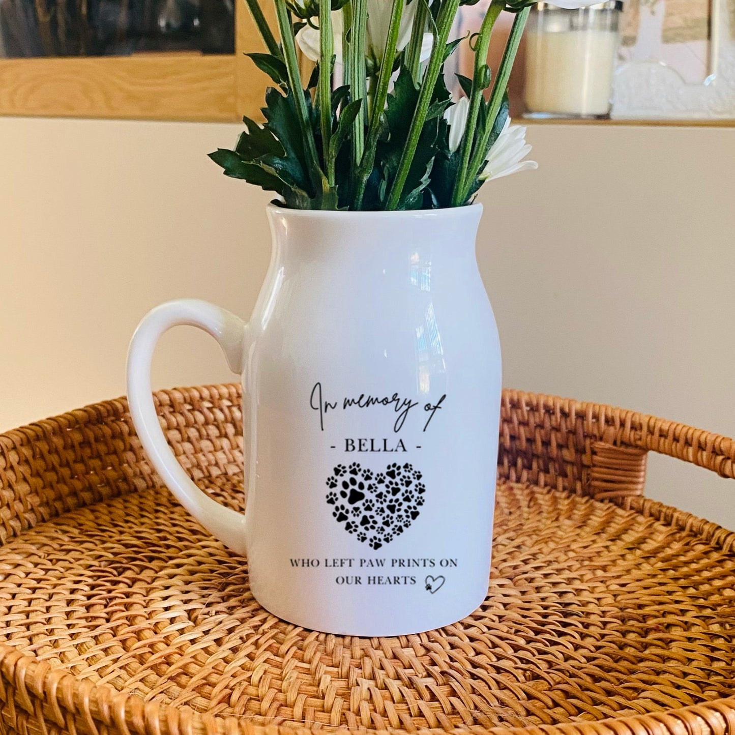 White Pet Memorial Vase pitcher with floral arrangement on a woven tray in a home setting