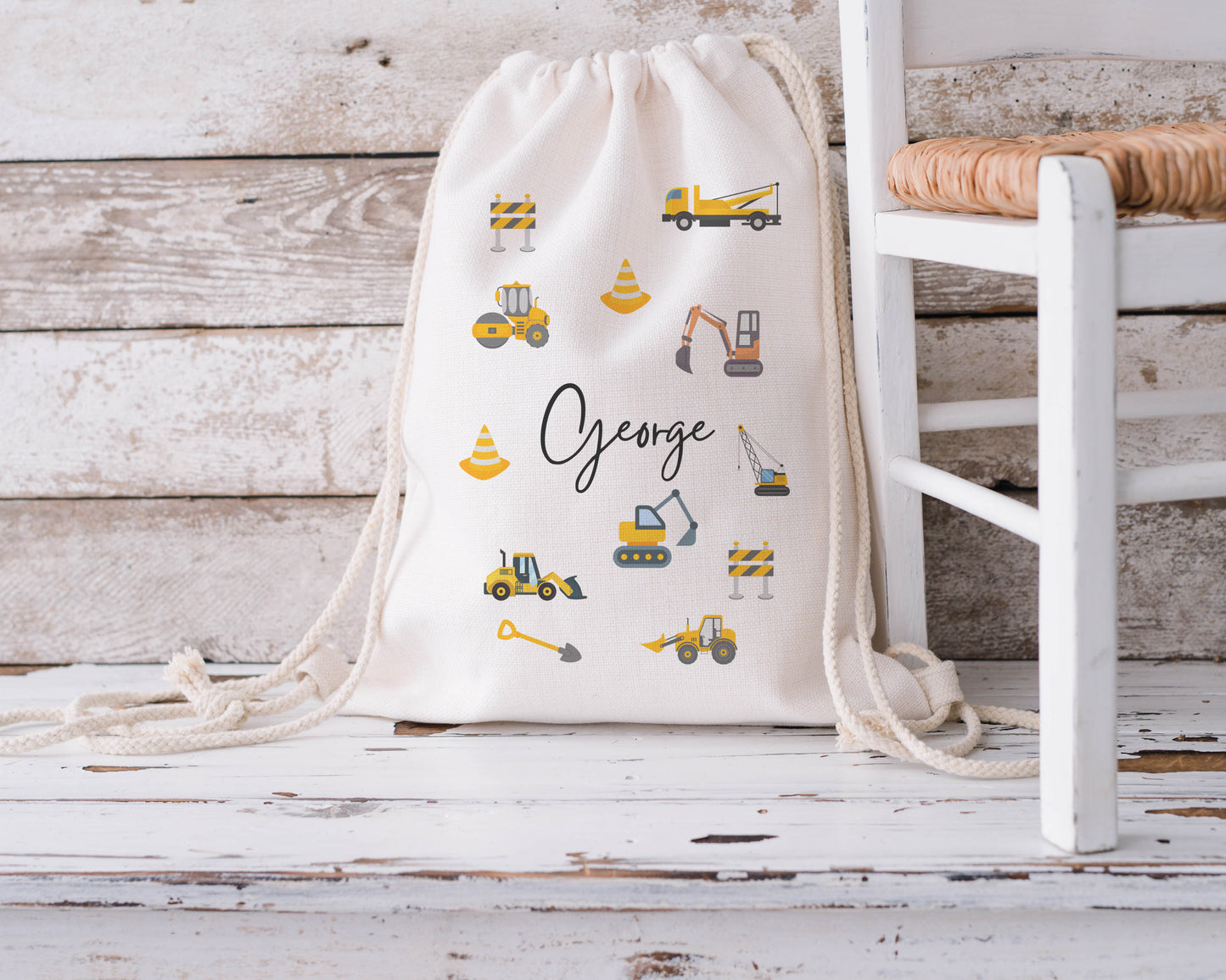 Personalised kids drawstring backpack featuring yellow diggers, construction vehicles and cones, custom name ‘George’ – ideal for nursery, school or PE bag