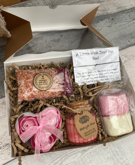 Gift set with bath products including soap and bath bombs in a box labeled 'A Little Wish Just For You'.