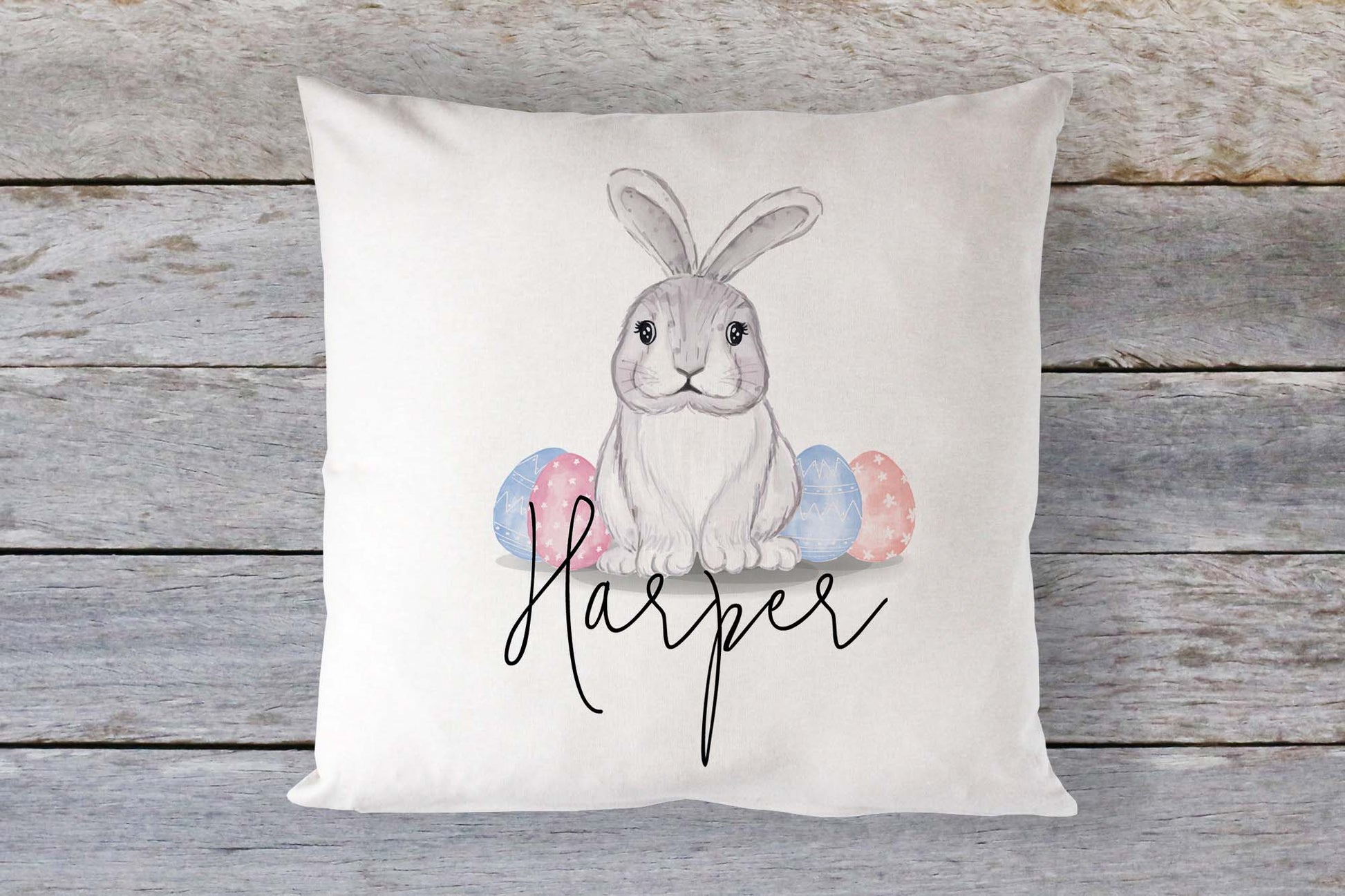 Unique personalised Easter bunny cushion featuring a soft pastel design with decorated eggs and custom name “Harper” – a charming gift for children or nursery décor.