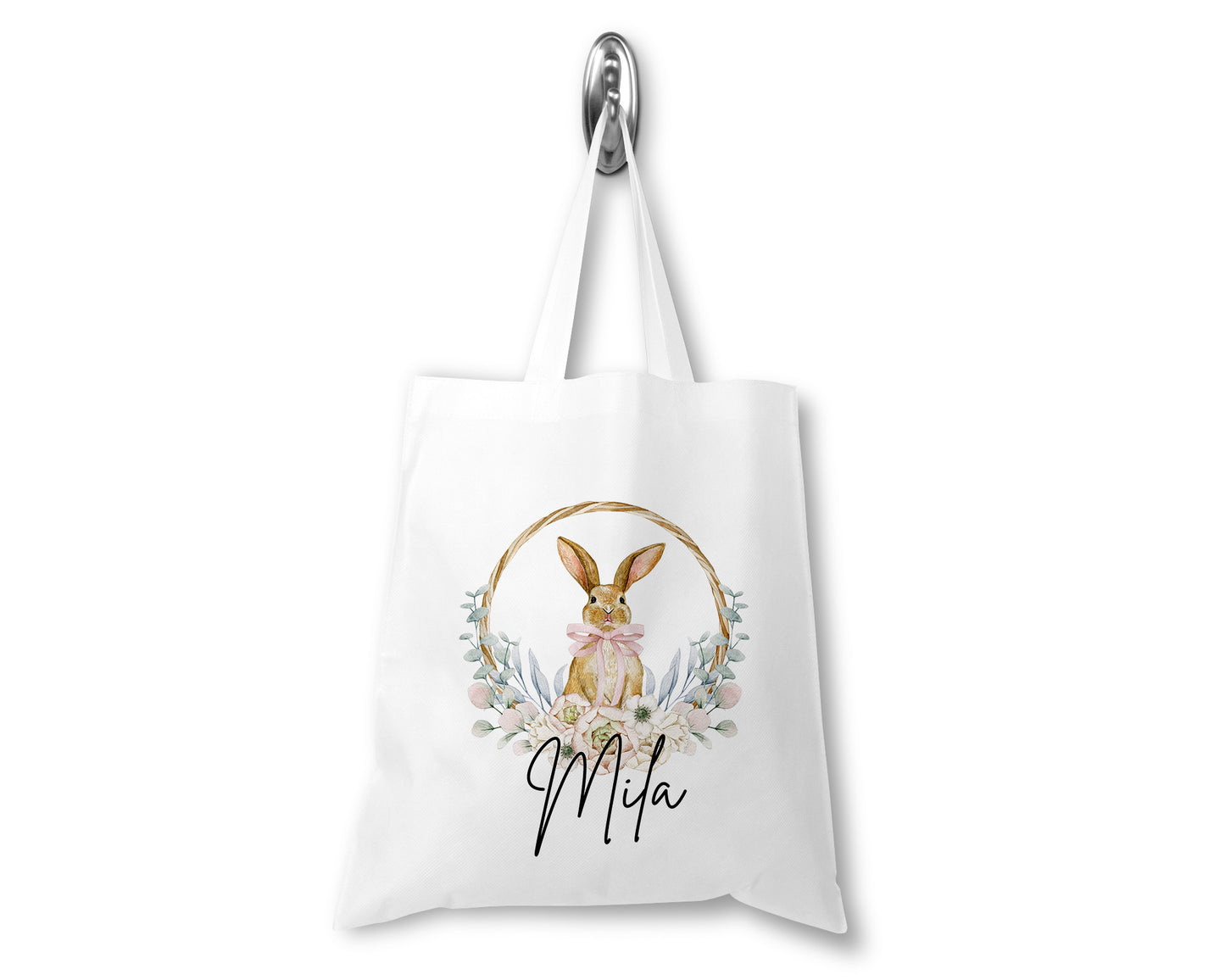 Personalised white Easter tote bag featuring a cute bunny with floral wreath and pink bow, custom name "Mila" in modern script. Ideal for Easter egg hunts, gift giving, or spring outings for kids. Eco-friendly reusable cotton bag.
