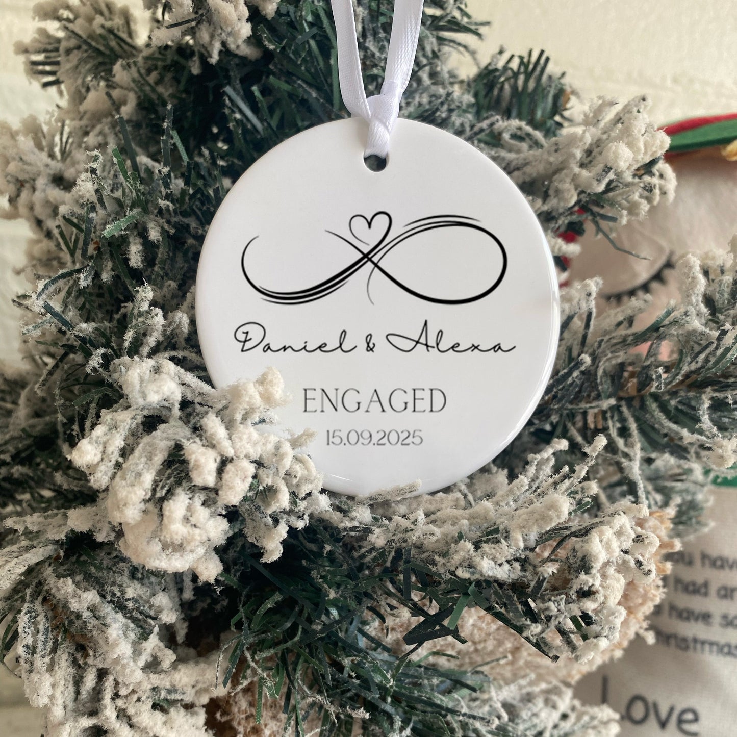 Decorative ornament with personalized text on a Christmas wreath