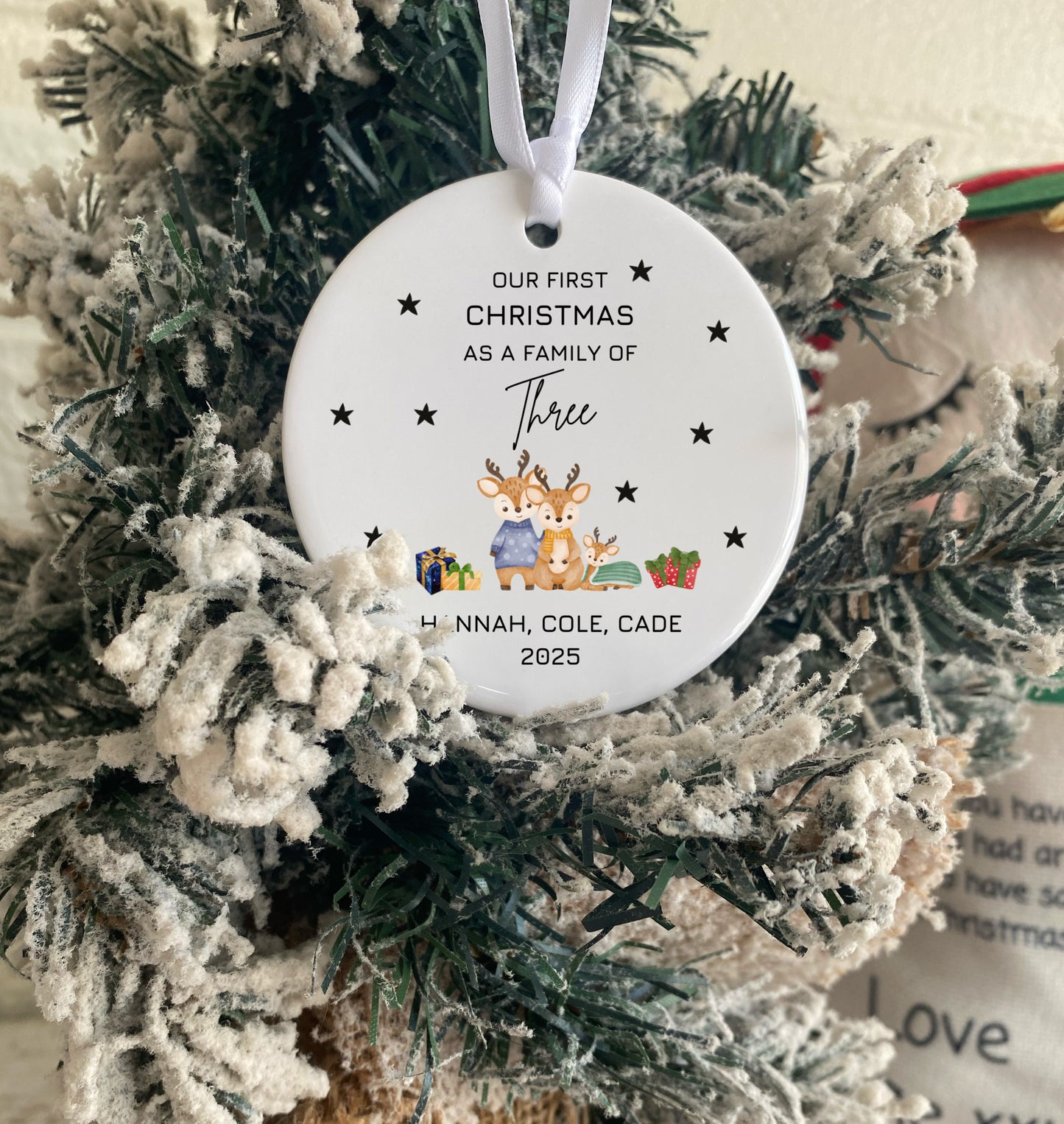 Personalized Christmas ornament with family of three design on a decorated tree.