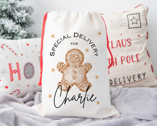 Personalised Christmas sack with gingerbread man design, custom name festive gift bag for children, small linen Santa sack with red drawstring