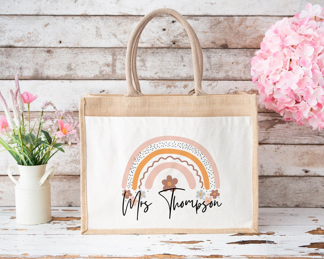 Unique personalised jute tote bag featuring a pastel rainbow and floral design with teacher’s name – thoughtful gift idea for end-of-term, teacher appreciation, or everyday use.