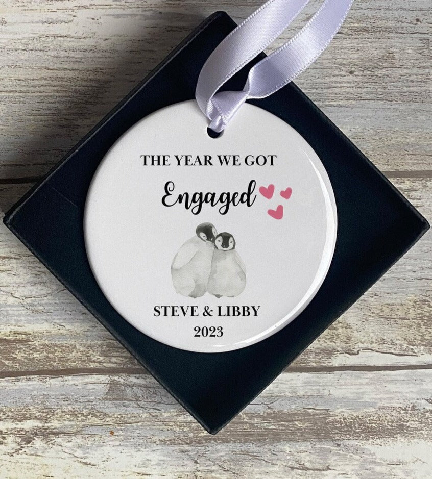 Personalised engagement keepsake ornament featuring penguin couple illustration with names and date – romantic gift idea for engaged couples or wedding announcements