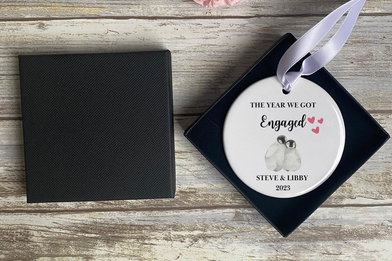 Personalised engagement ornament with penguin couple illustration and ribbon, featuring custom names and date – romantic keepsake gift for newly engaged couples, perfect for Christmas or proposal celebrations