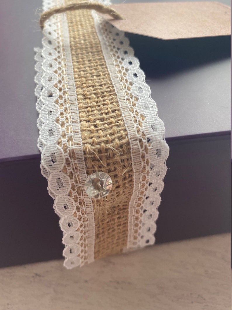 Close-up of a burlap ribbon with lace edge on a neutral background