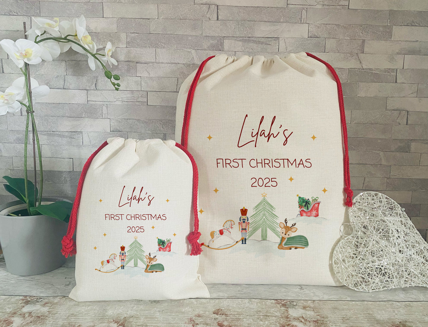 First Christmas 2025. Personalised Christmas Sacks. One Large and One Small with red cord and a festive motive