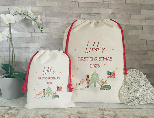 First Christmas 2025. Personalised Christmas Sacks. One Large and One Small with red cord and a festive motive