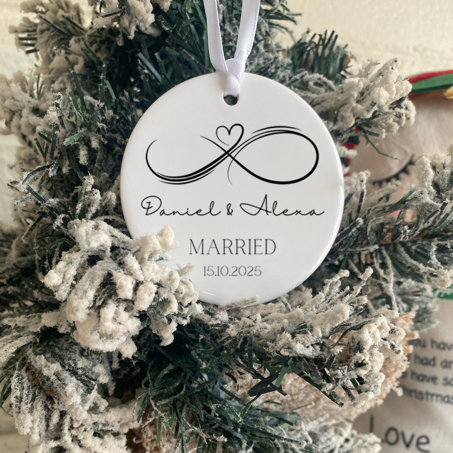 Decorative ornament with monogram and text on a Christmas wreath