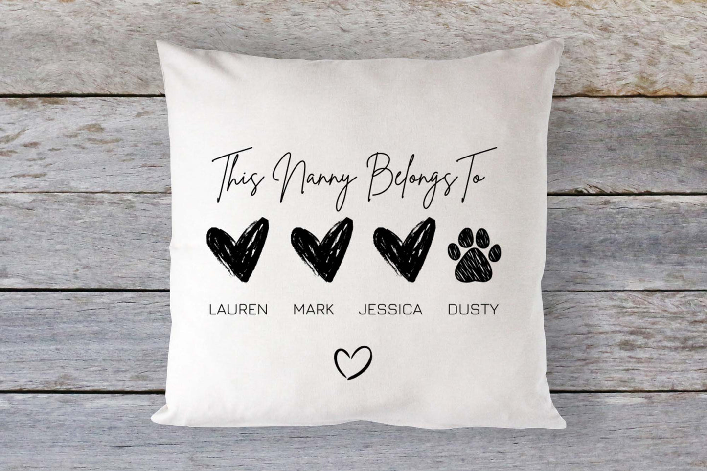 Personalised “This Nanny Belongs To” cushion with black heart and paw print illustrations, customised with family names including pet. Thoughtful gift for Nanny, perfect for Mother's Day or birthdays, home decor with sentimental value and custom family touch.