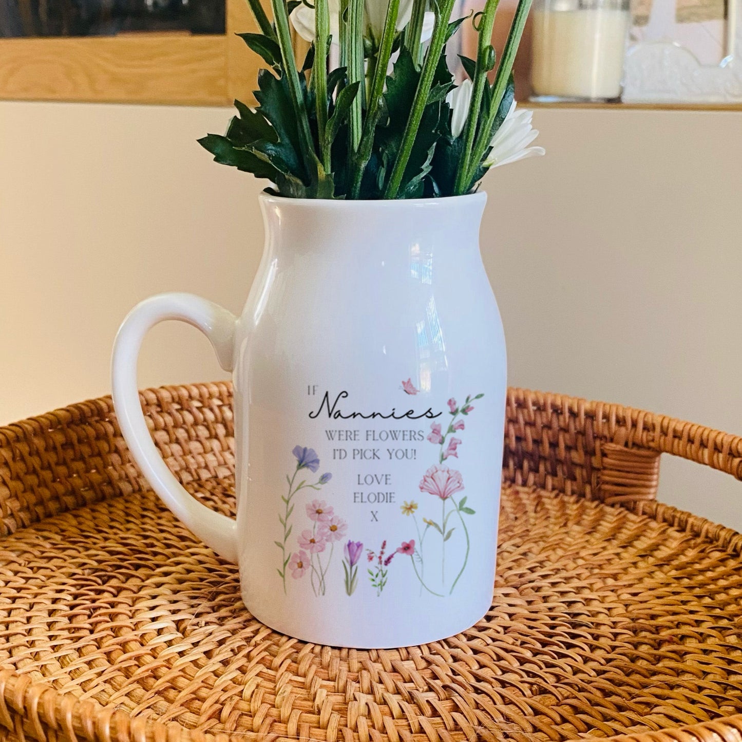 Personalised White vase with floral design on a woven tray. Personalised with 'If Nannies were flowers I'd Pick You'