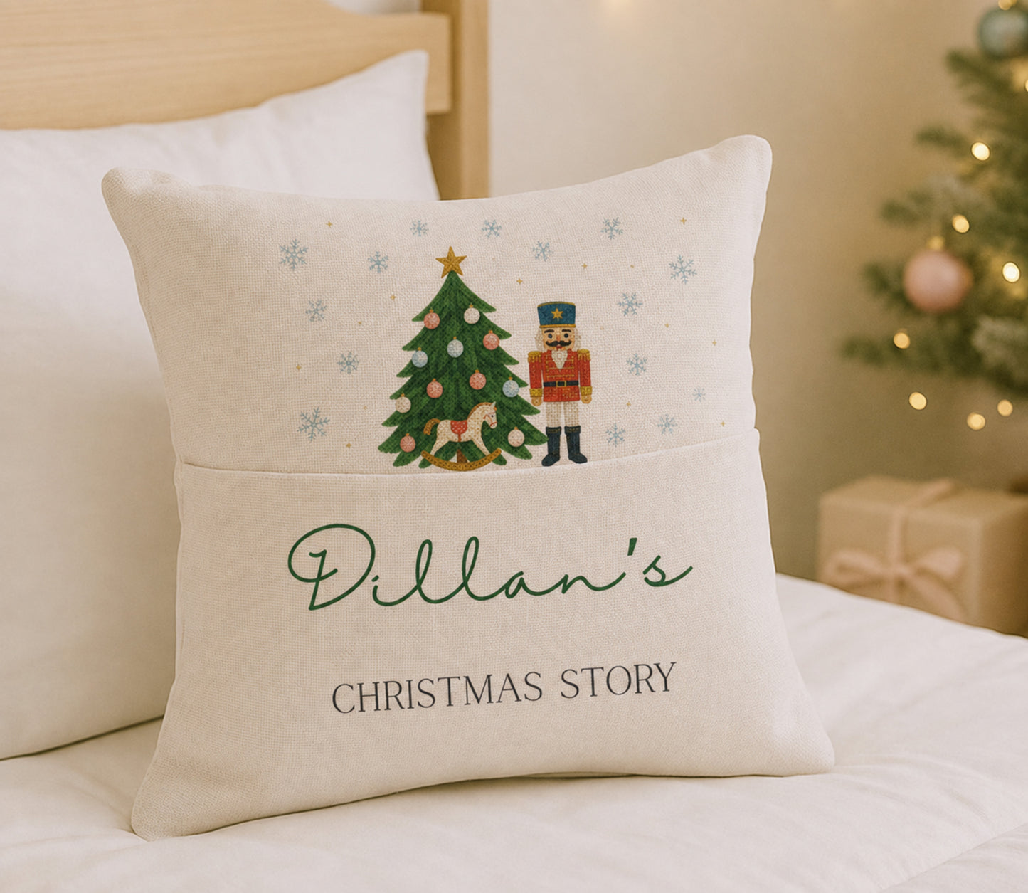 A square cream-colored throw pillow with a printed Christmas nutcracker and tree design on the top half and the personalized text 'Dillan's CHRISTMAS STORY' on the bottom half, resting on a bed in a cozy bedroom setting.