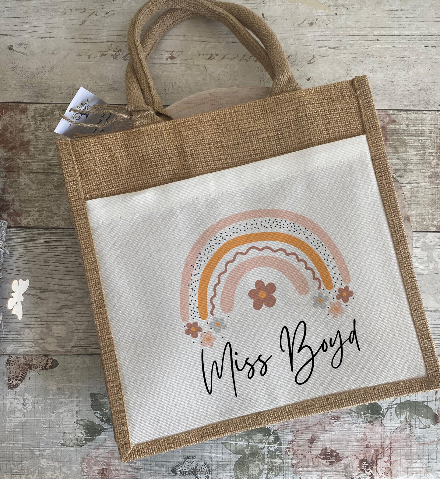 Unique personalised jute gift bag featuring pastel rainbow and floral illustration with custom name "Miss Boyd" – ideal thank you teacher gift for end of term or classroom appreciation.