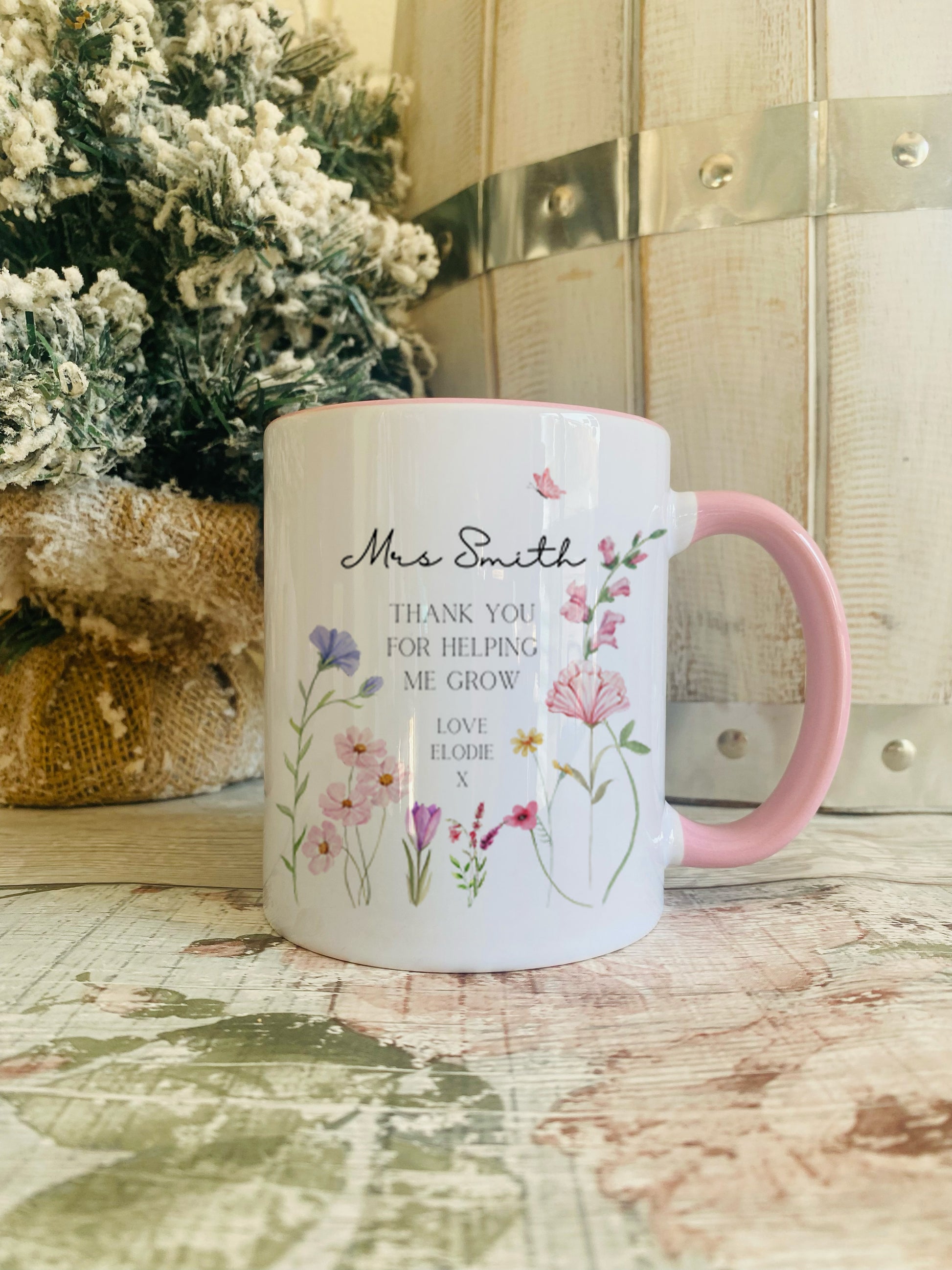 Personalised  Teacher Pink Handled Mug. Featuring the saying 'Thank you for helping me grow' and personalised with the teachers name along with who it's from.