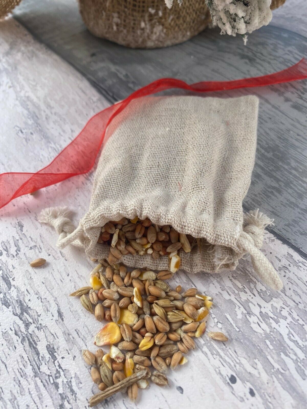 Hessian bag with spilled seeds on a wooden surface