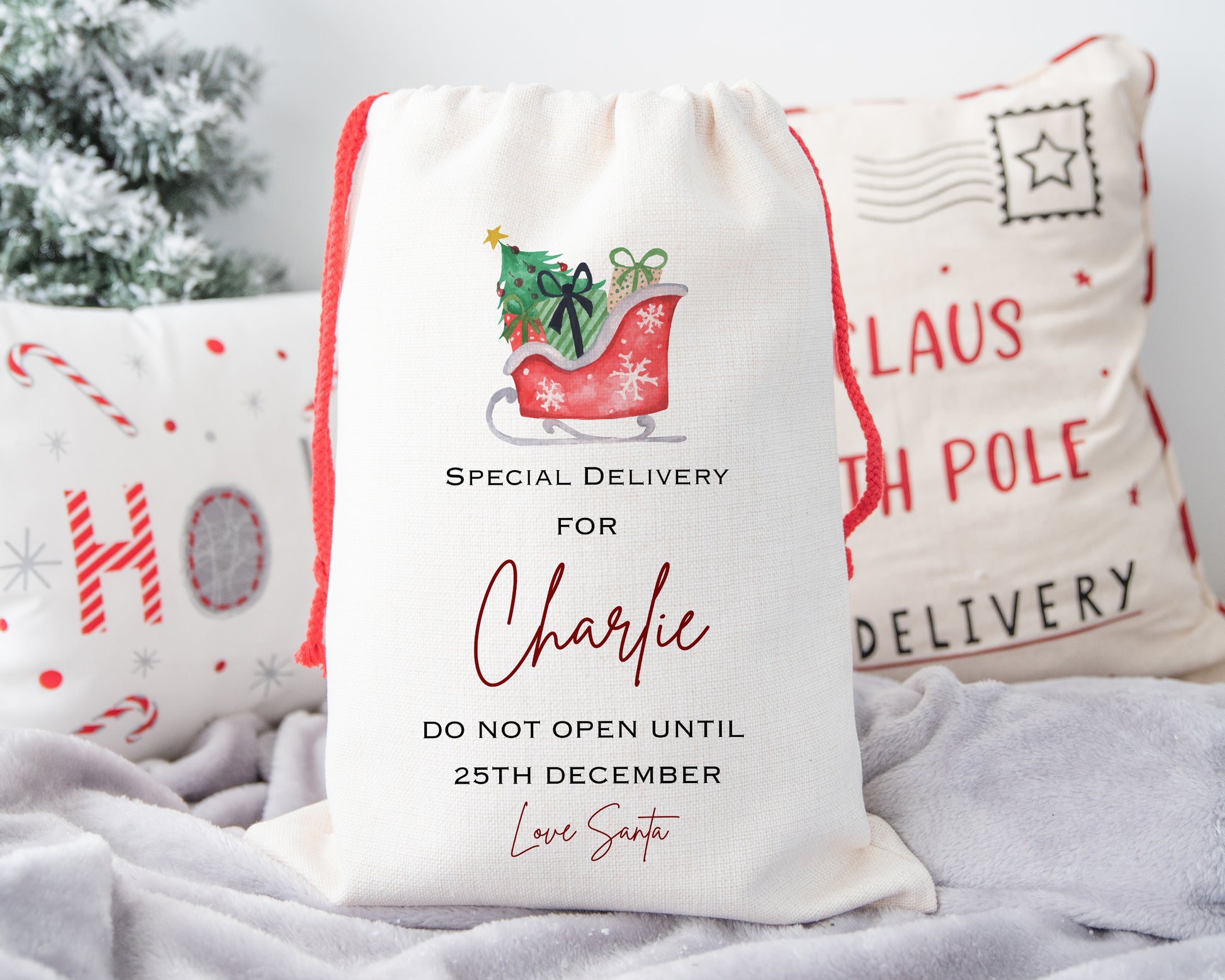 Unique personalised Christmas gift sack with red sleigh and presents – “Special Delivery for Charlie – Do Not Open Until 25th December – Love Santa” – custom festive Santa sack gift