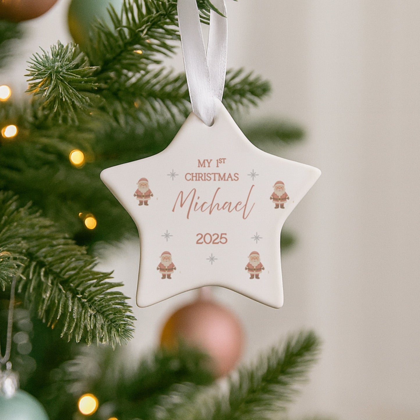 Star-shaped Christmas ornament with 'My 1st Christmas Michael 2025' text on a decorated tree.