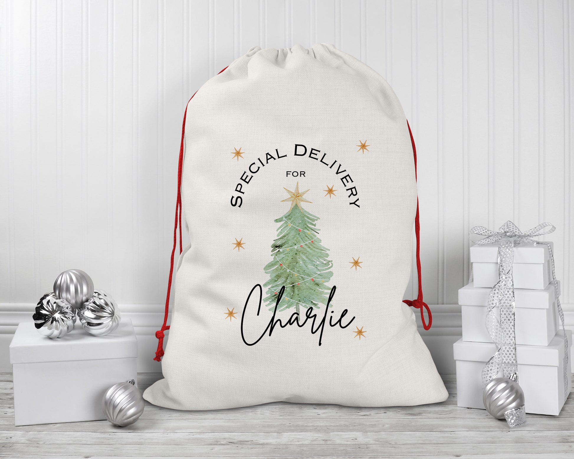 Large personalised Christmas sack with special delivery message, green festive tree, and name Charlie on cream drawstring bag