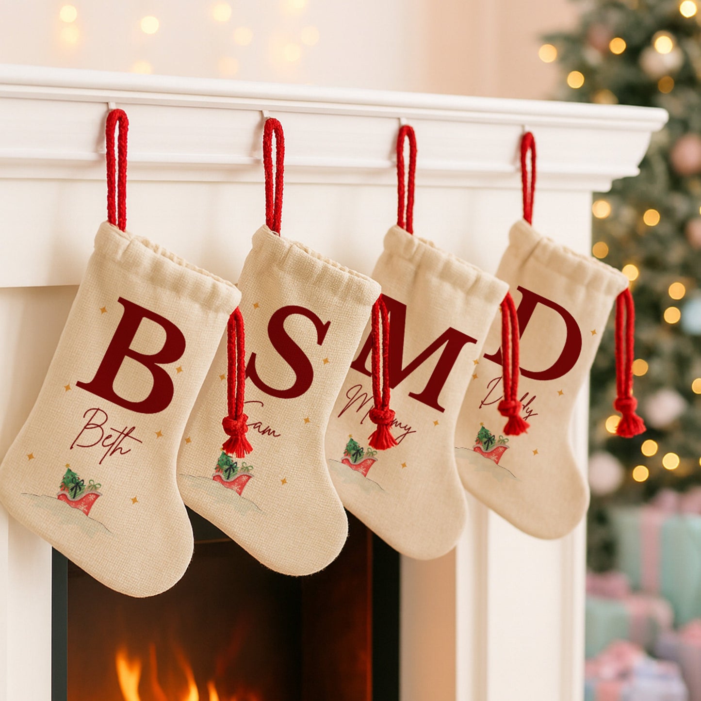 Four Christmas stockings with monogrammed letters hanging on a fireplace mantle.
