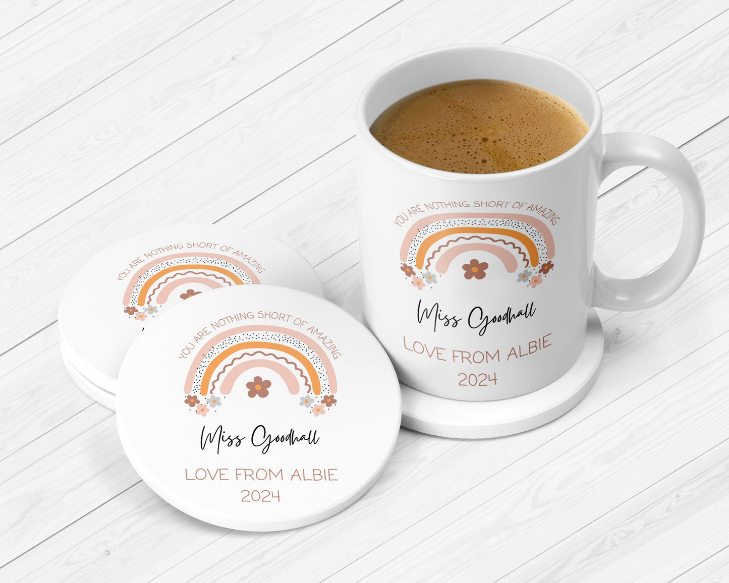 Custom ceramic mug and matching coasters featuring a warm-toned rainbow, floral details, and the quote “You are nothing short of amazing.” Personalised with “Miss Goodhall – Love from Albie 2024.” Ideal thank you gift for teachers and teaching assistants.