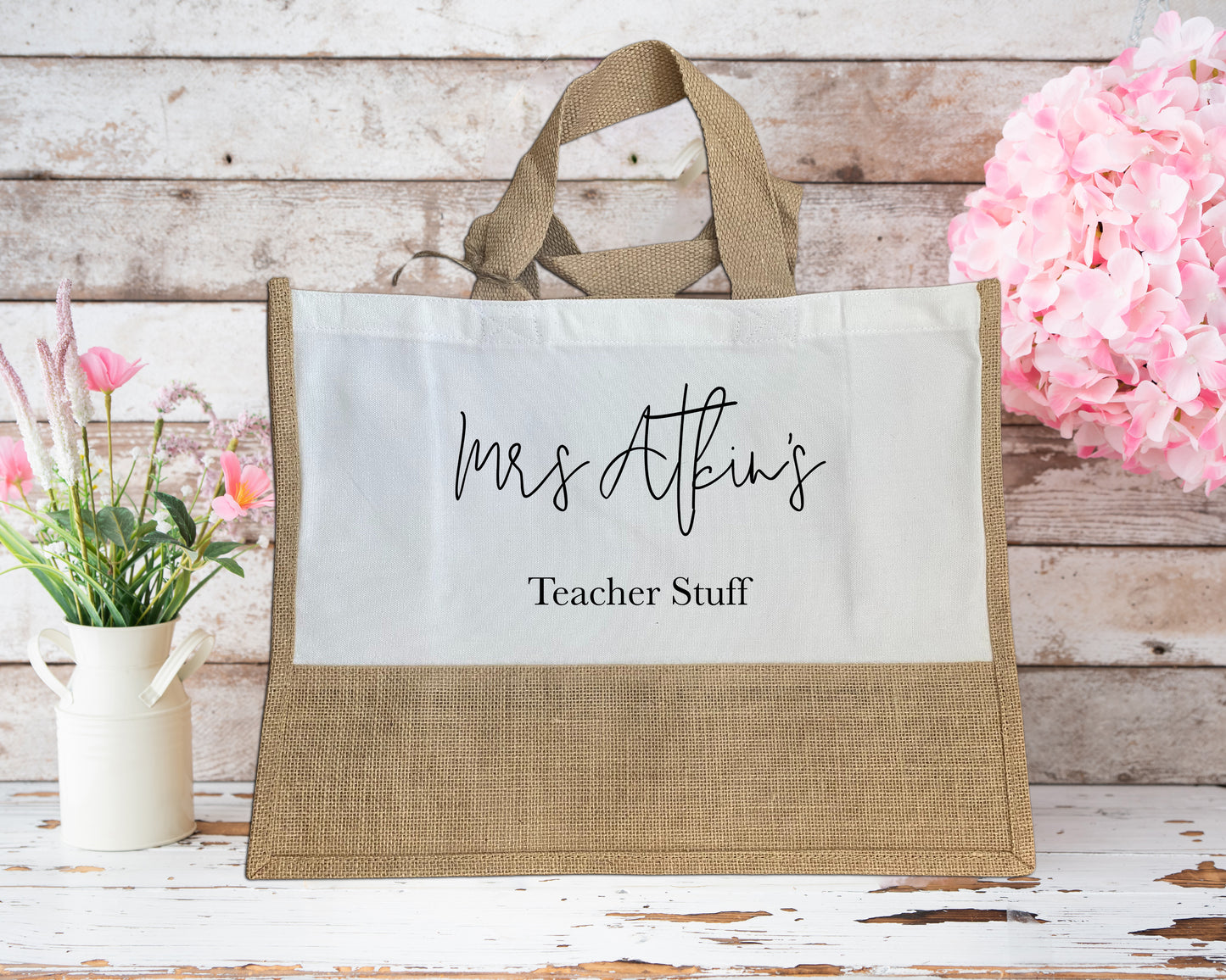 Personalised large jute teacher tote bag with “Mrs Atkin’s Teacher Stuff” printed in black script on a white panel, perfect for school supplies and daily essentials.