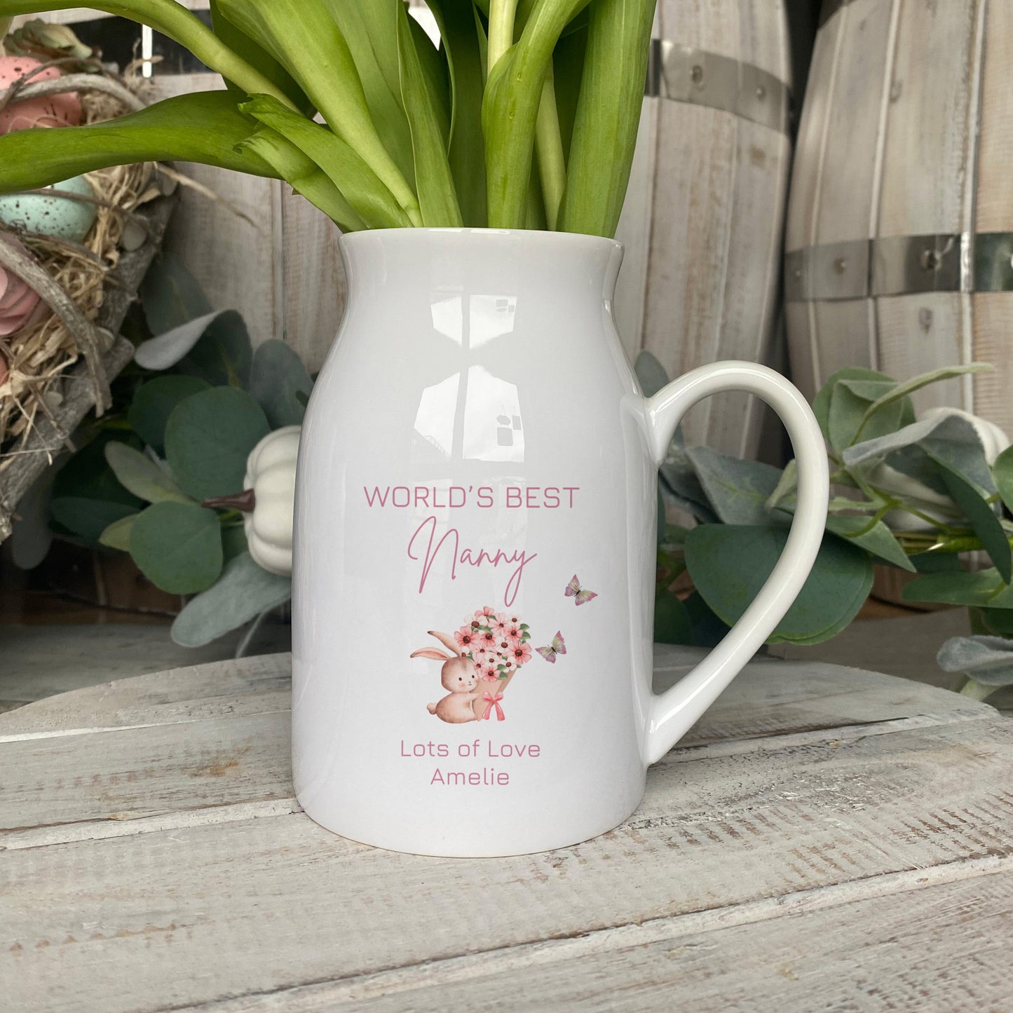 Personalised ceramic jug with 'World’s Best Nanny' text, pink floral bunny design, and custom message from grandchild