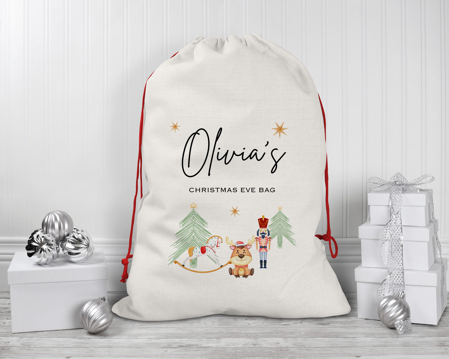 Personalised Christmas Eve bag with Olivia’s name, red drawstring, nutcracker, rocking horse, and reindeer design on large linen sack