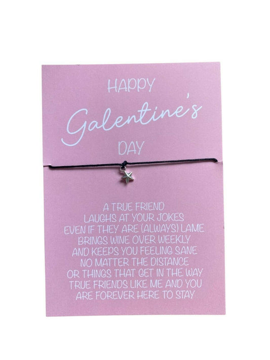 A pink wish bracelet with a silver-plated Tibetan charm on an A6 card, with a humorous message printed on the card, indicating it is a gift for Galentine's Day.