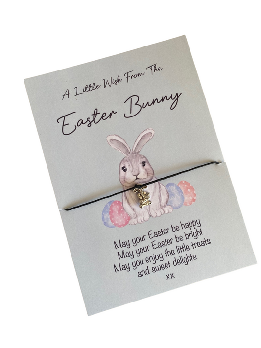 A bracelet with a bunny-shaped silver charm, attached to a card with a printed message and a bunny illustration.
