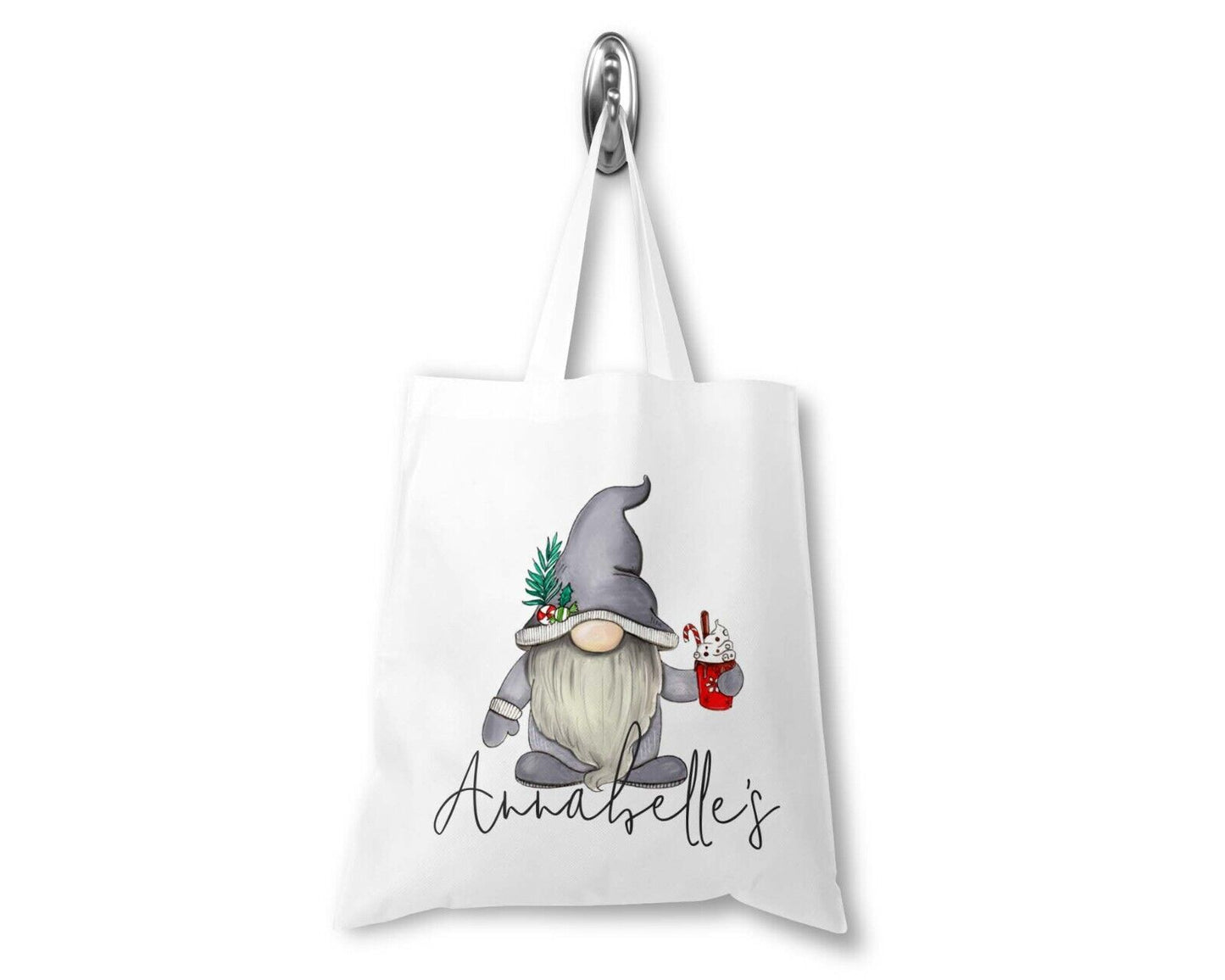 A white polyester Christmas gift bag with a sublimation printed gnome design and the personalised text 'Aubriella's'.