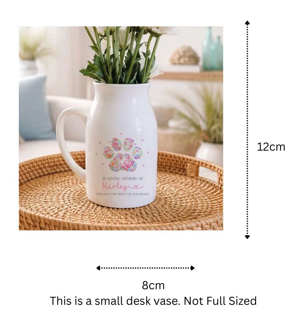 White pet memorial pitcher with floral design on a woven tray in a living room setting with dimensions