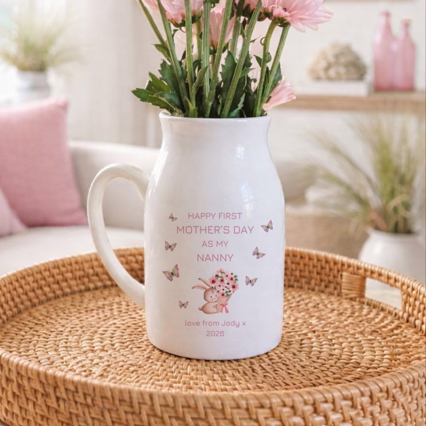 Personalised ceramic jug with 'Happy First Mother's Day as my Nanny' message, featuring a bunny holding flowers and butterflies, perfect gift from grandchild
