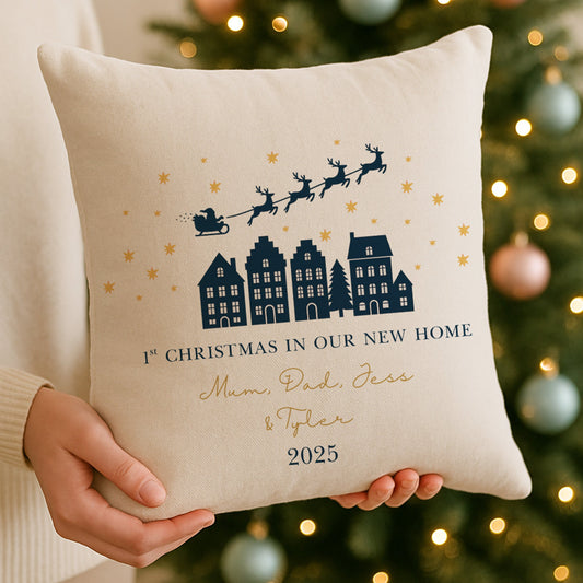 Decorative pillow with Christmas text held in front of a decorated tree