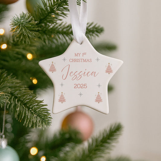 Personalised Christmas ornament on a decorated tree with lights.