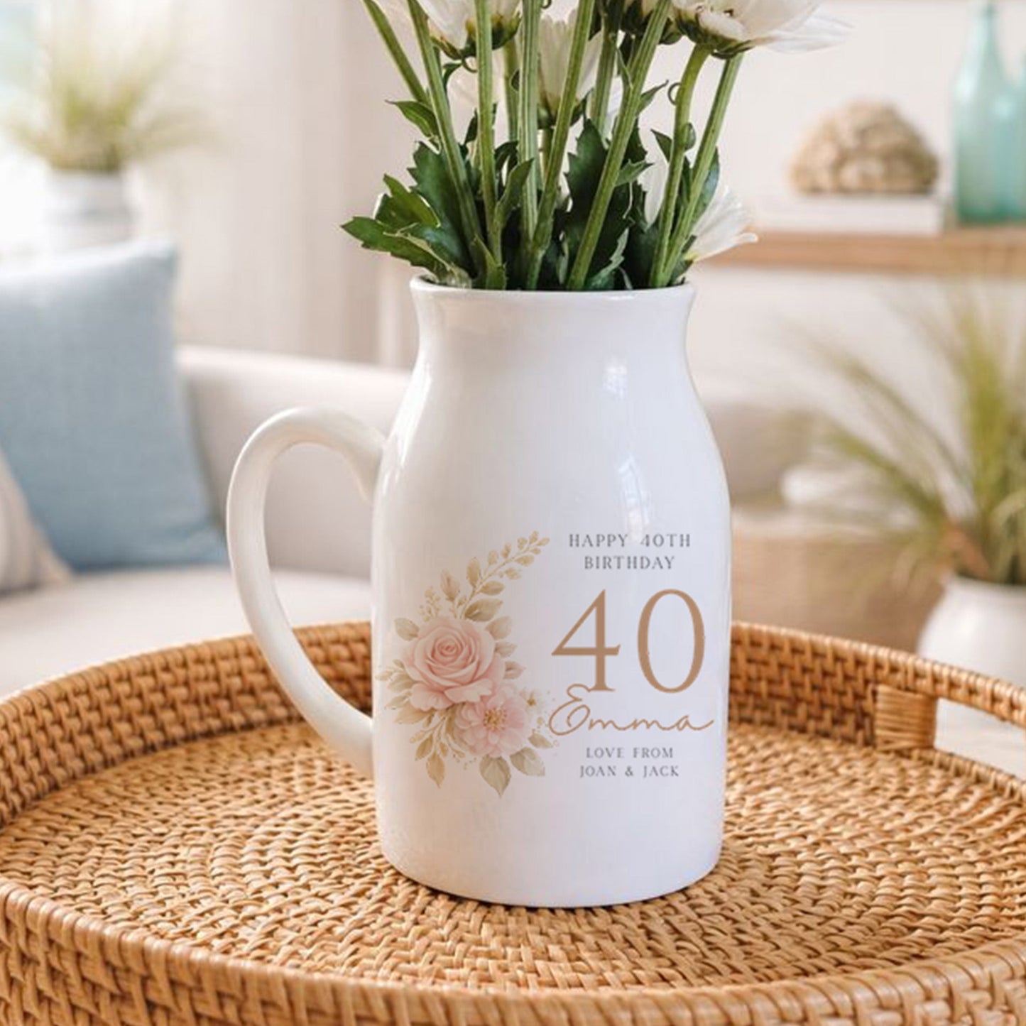 White pitcher with floral design on a woven tray in a living room setting