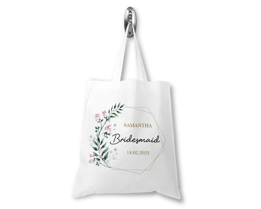 White tote bag with floral design and text on a white background