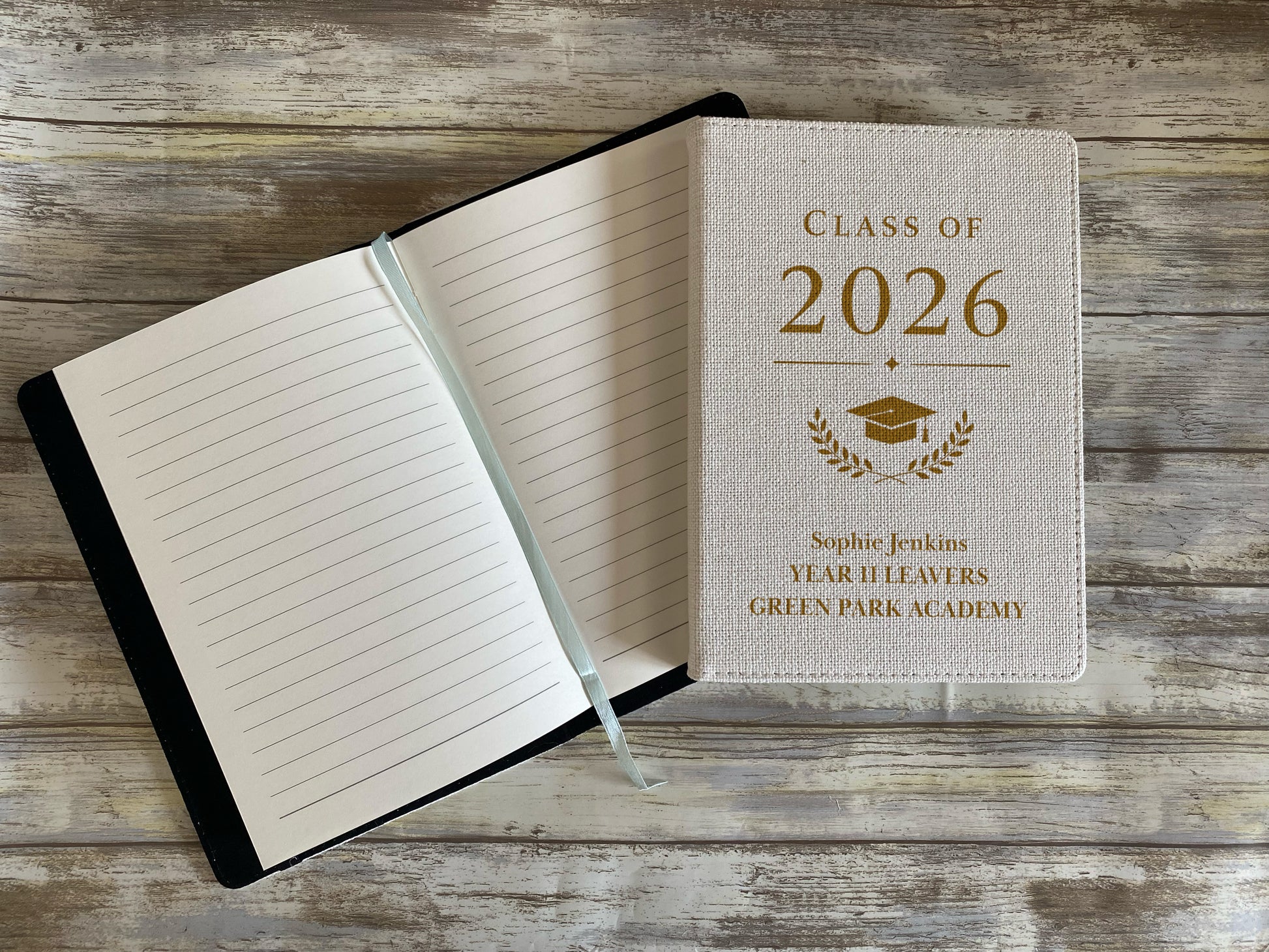 Graduation-themed notebook with 'Class of 2026' text on a wooden surface