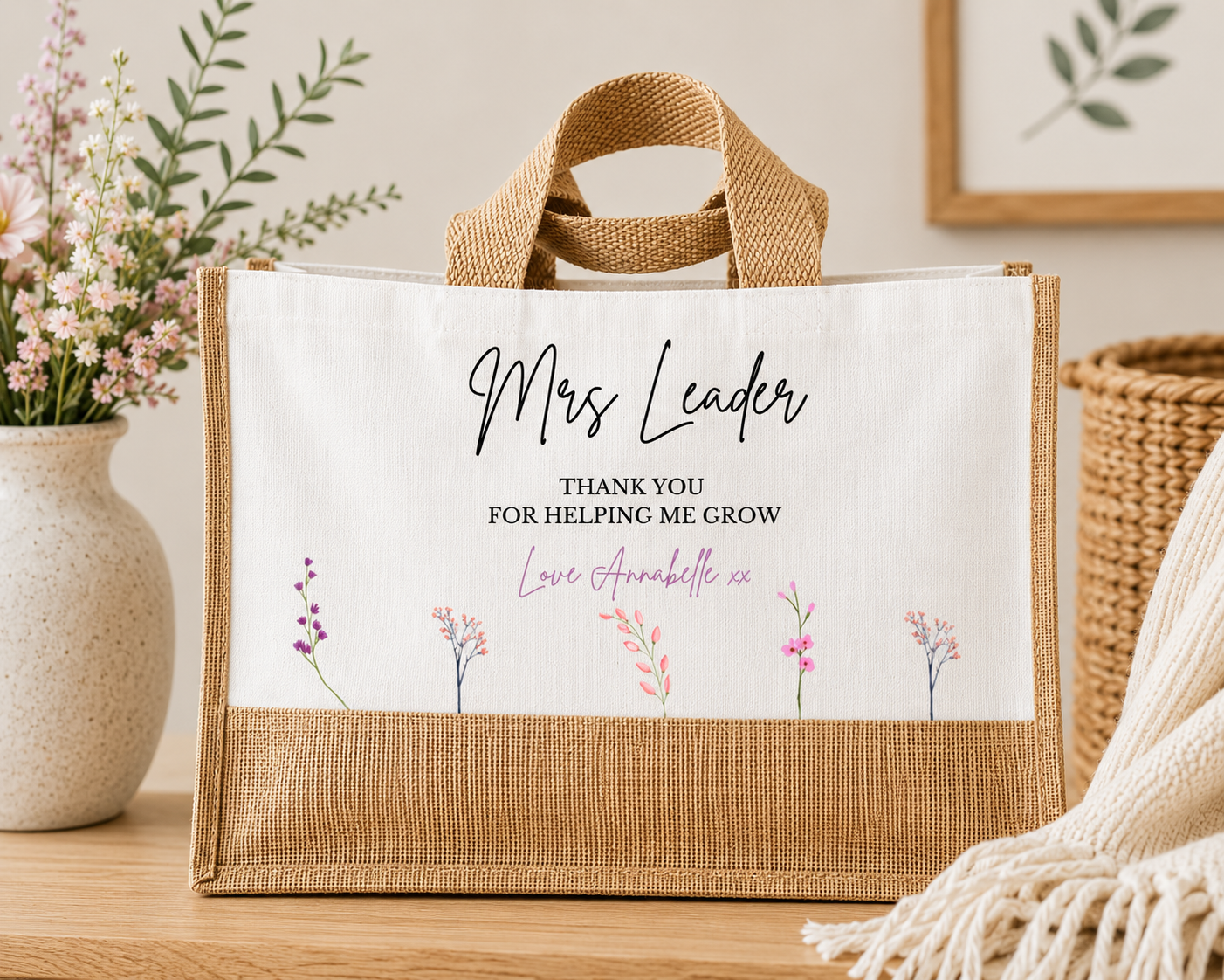 Personalised Teacher Burlap tote bag with custom name 'Thank you for helping me grow' text and floral design on a wooden surface. 