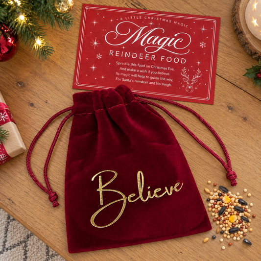 A bag of magical Reindeer Food presented in a red velvet pouch, with the word 'Believe' printed on the outside. Complete with a magical poem card.