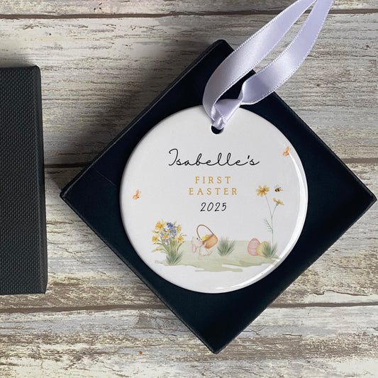 Baby’s first Easter ceramic keepsake with pastel flowers, bunny, and text, shown with gift box and ribbon